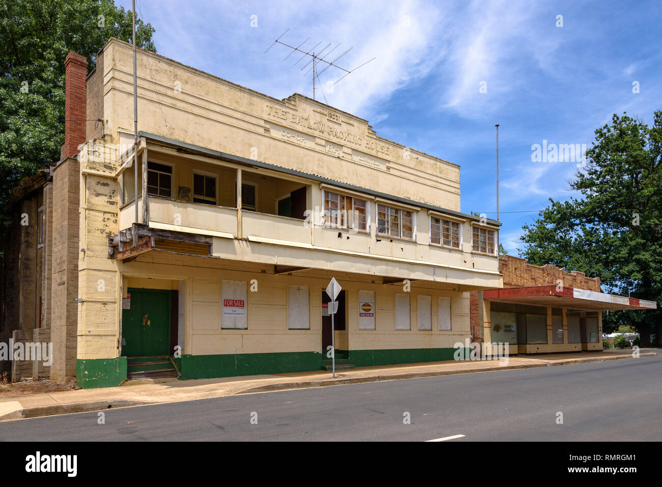 The boardedup Batlow Packing House for sale on a sunny summer day