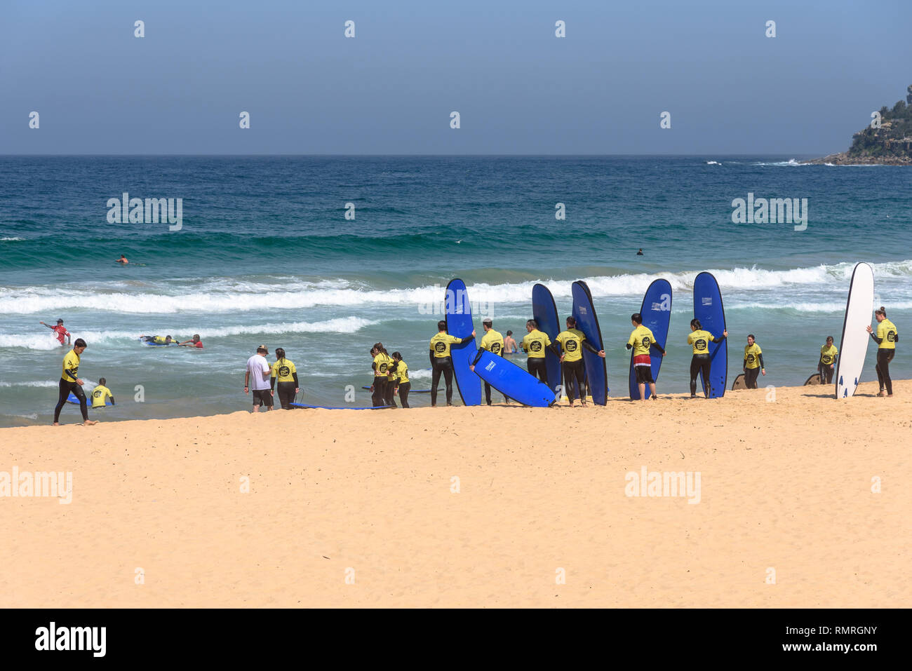 Students of the Manly Surf School lined up on the beach Stock Photo