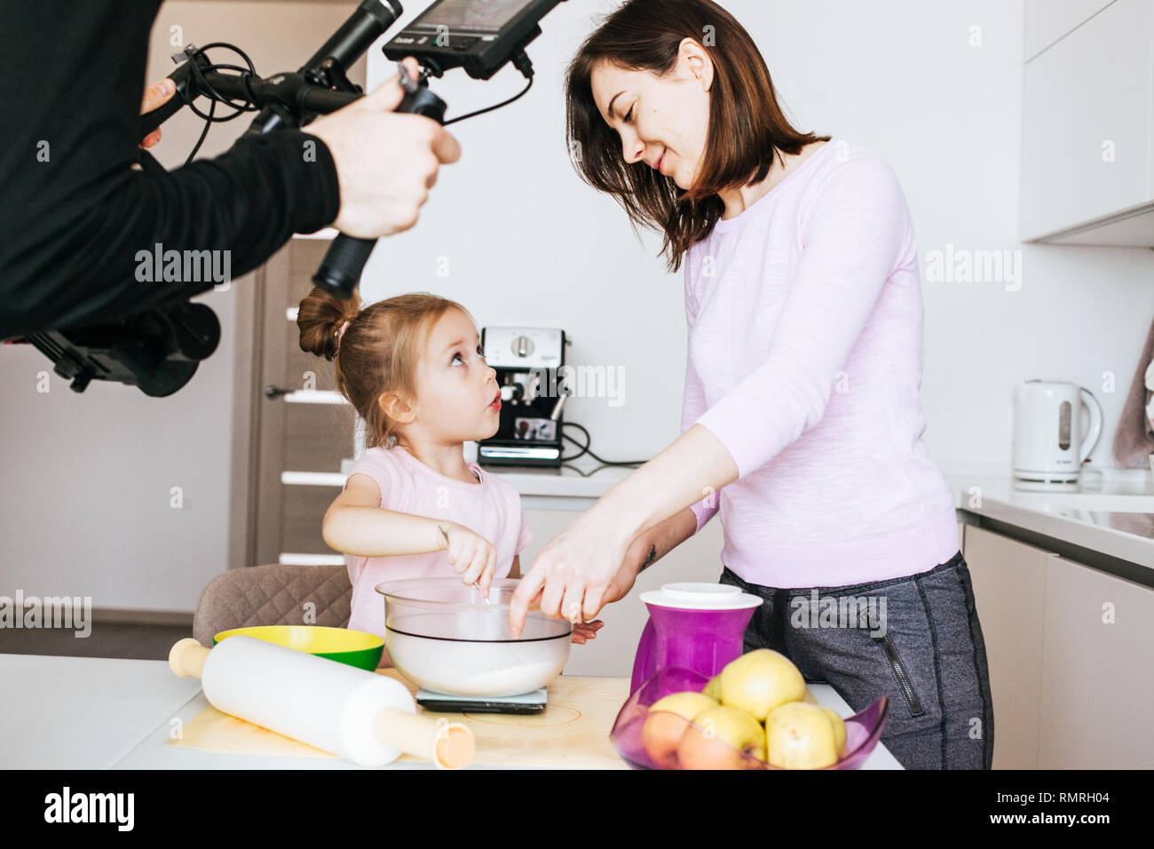 Mother and Daughter Baking Cookies at home and having fun together Stock Photo