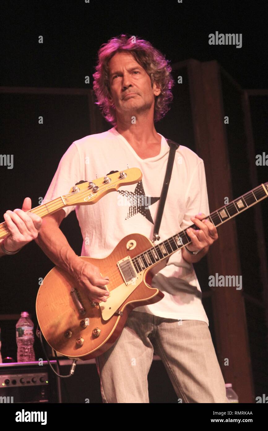 Musician Billy Squier is shown performing on stage during a "live
