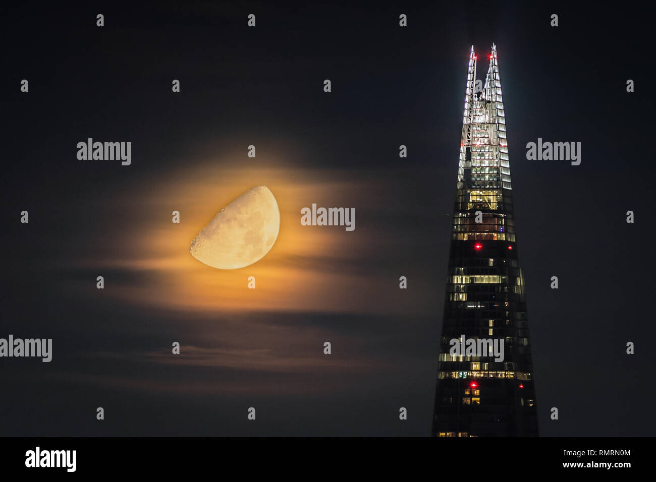 Waxing Gibbous Moon sets over the The Shard skyscraper in London Stock Photo