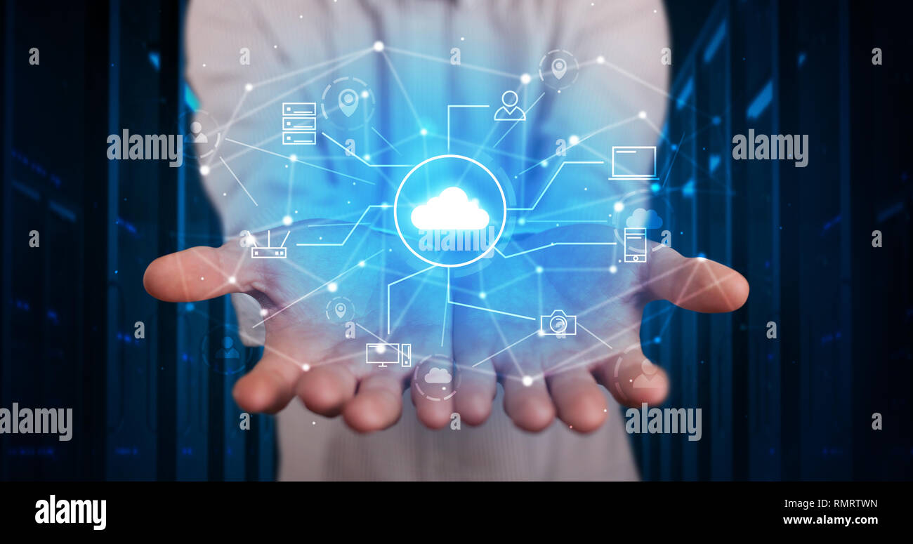 Man holding hologram projection displaying cloud technology symbols  Stock Photo
