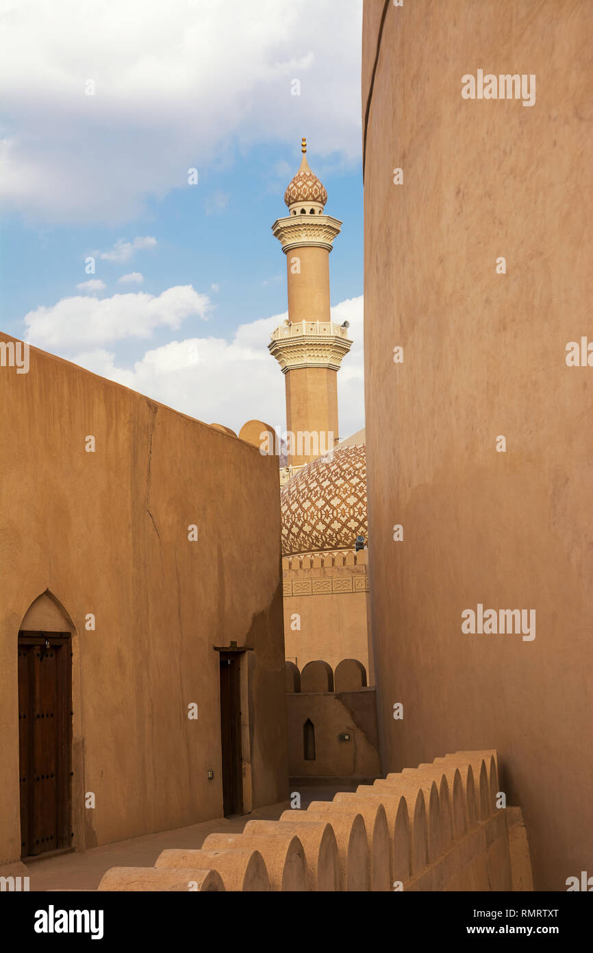 Detail of the minaret of the Nizwa Mosque seen from inside the Nizwa Fort Stock Photo