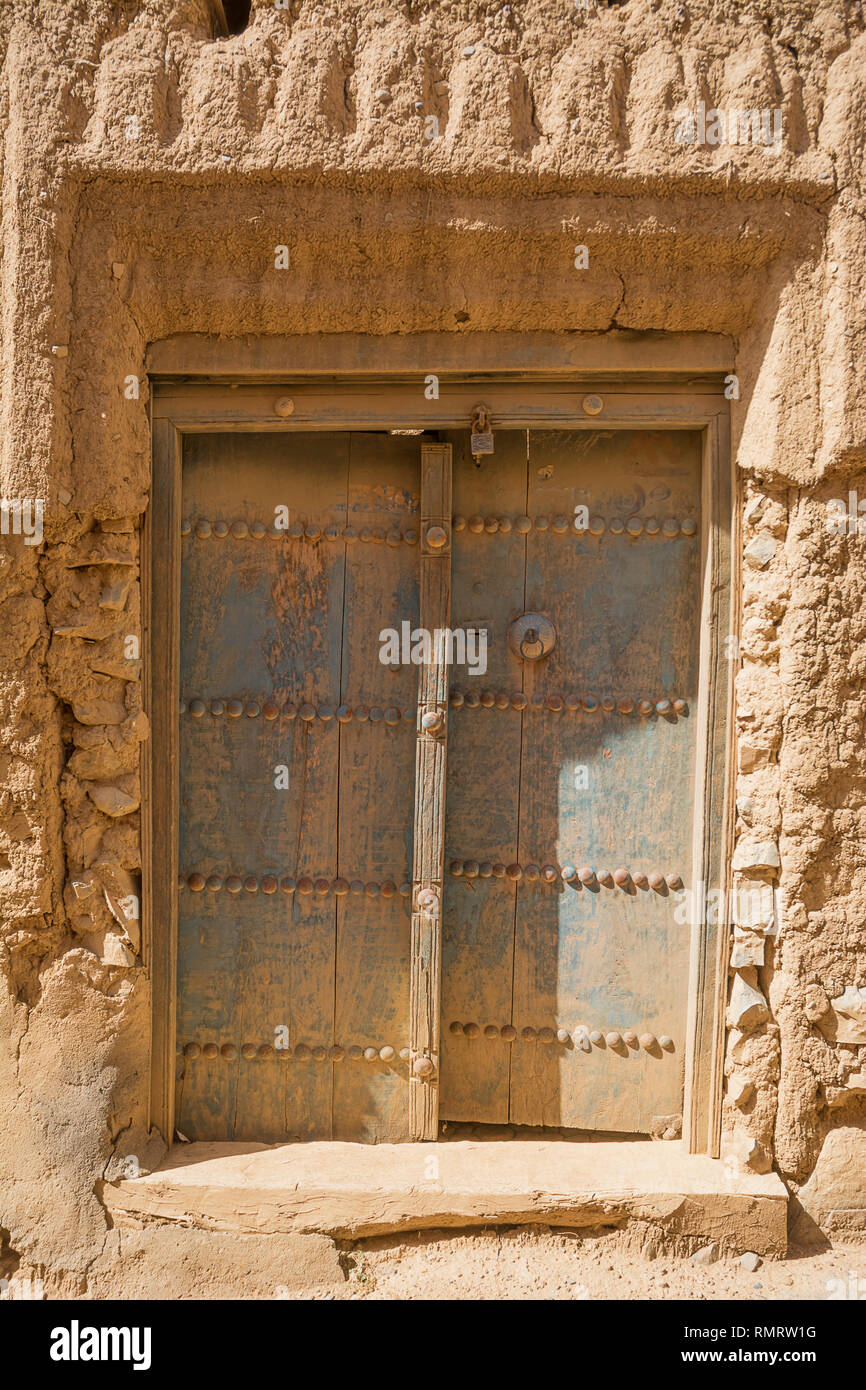 Ancient door of a mud house in the old village of Al Hamra (Oman) Stock Photo