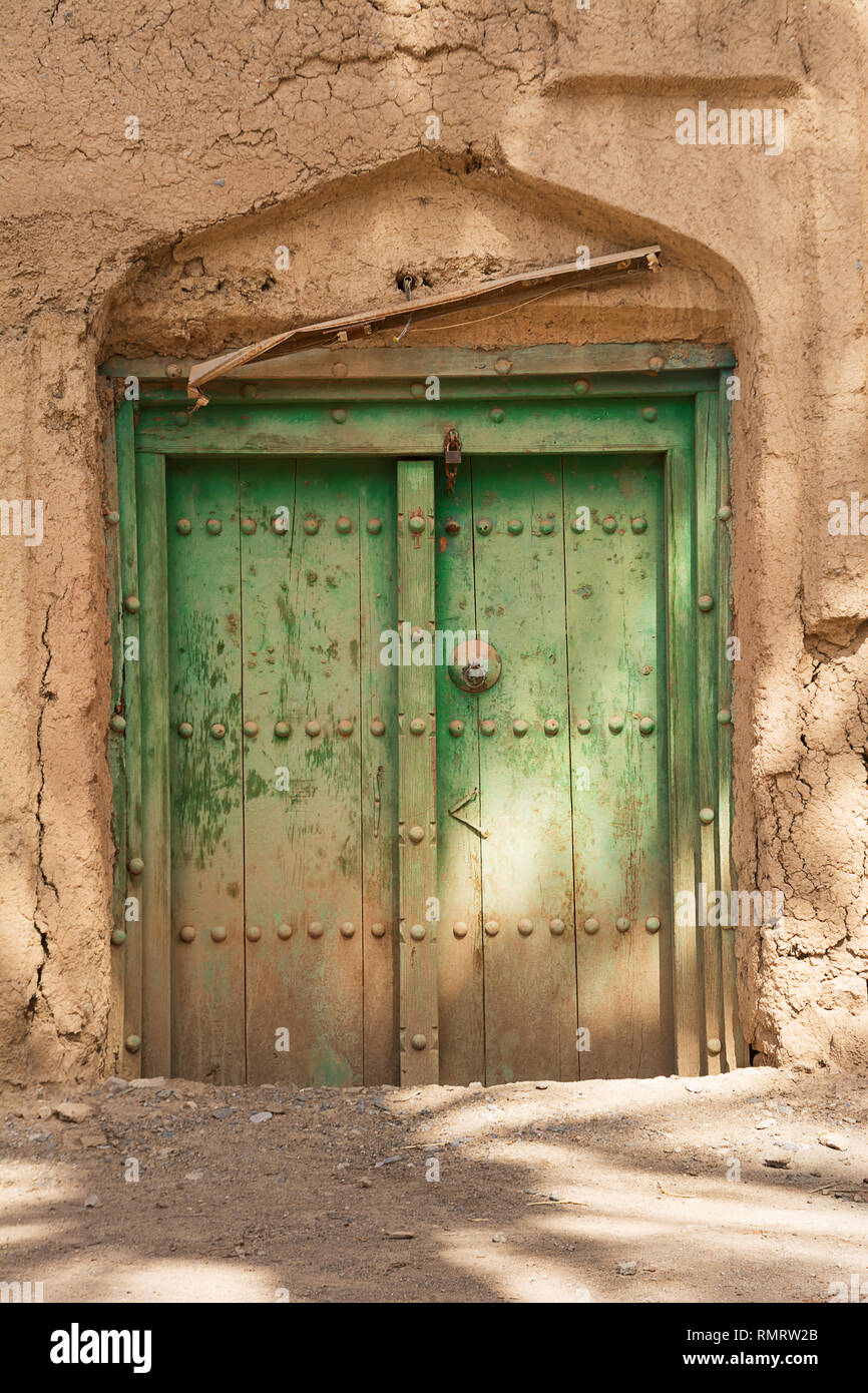 Ancient door of a mud house in the old village of Al Hamra (Oman) Stock Photo