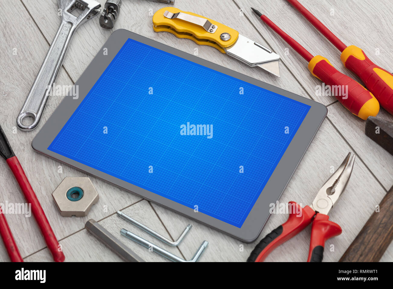 Household tools and tablet with grid screen concept Stock Photo