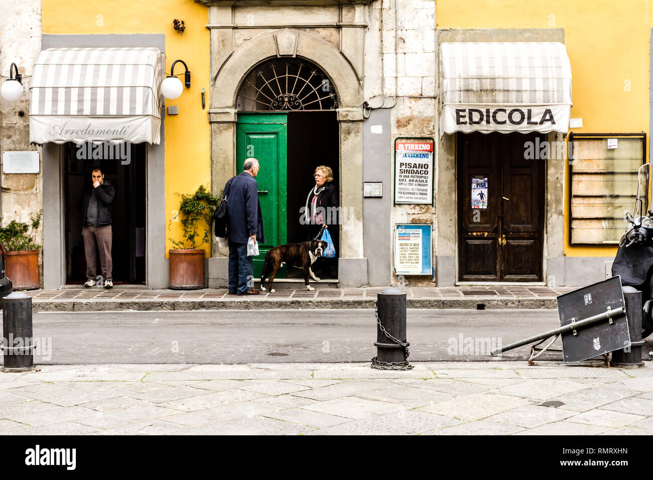 Pisa, Italy - March 17, 2012: Neighbors talking near the house on the street in the city of Pisa. Stock Photo
