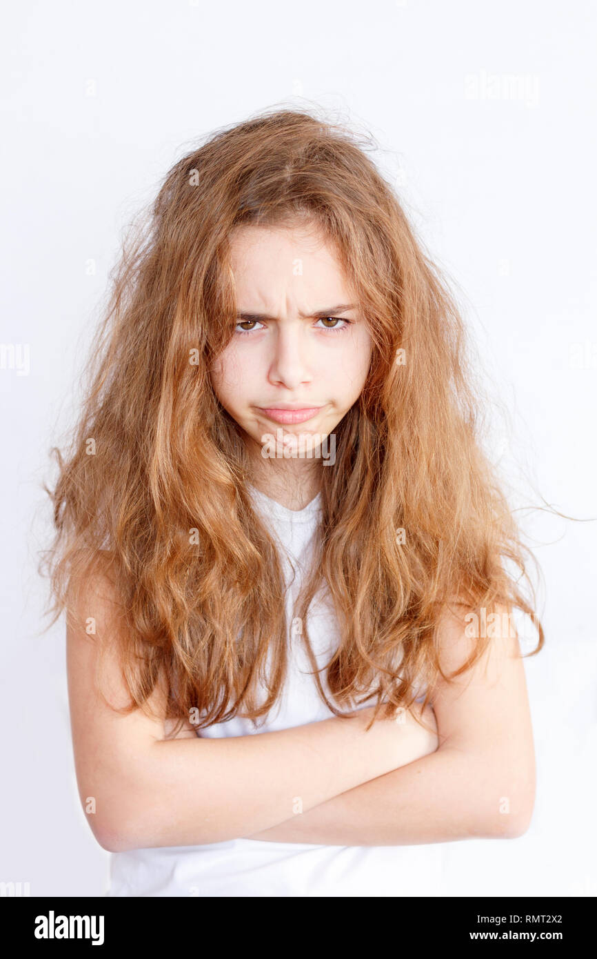 Pretty teenager girl with a long hair makes very angry funny face Stock  Photo - Alamy