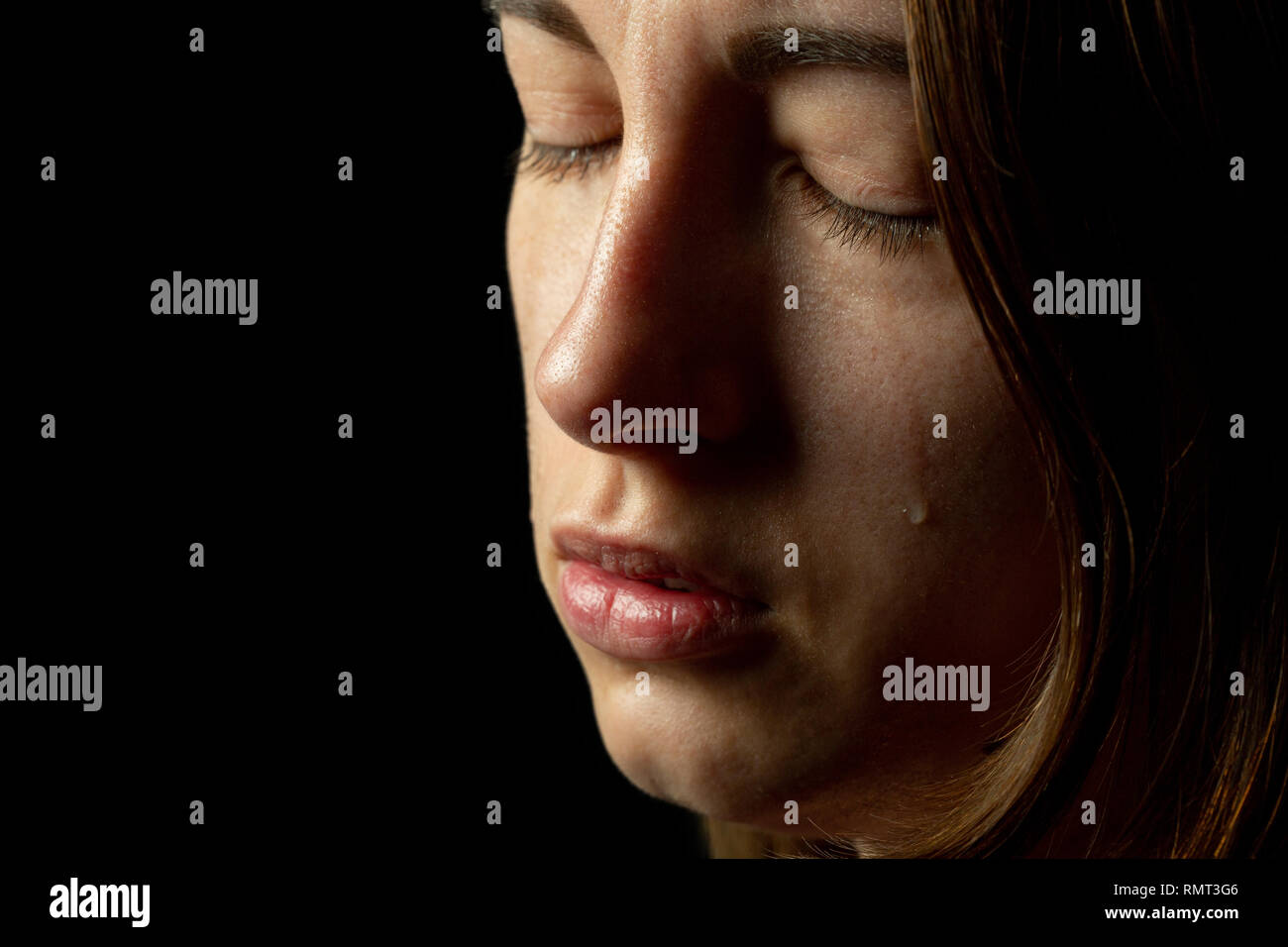 sad woman crying on black background, closeup portrait Stock Photo - Alamy
