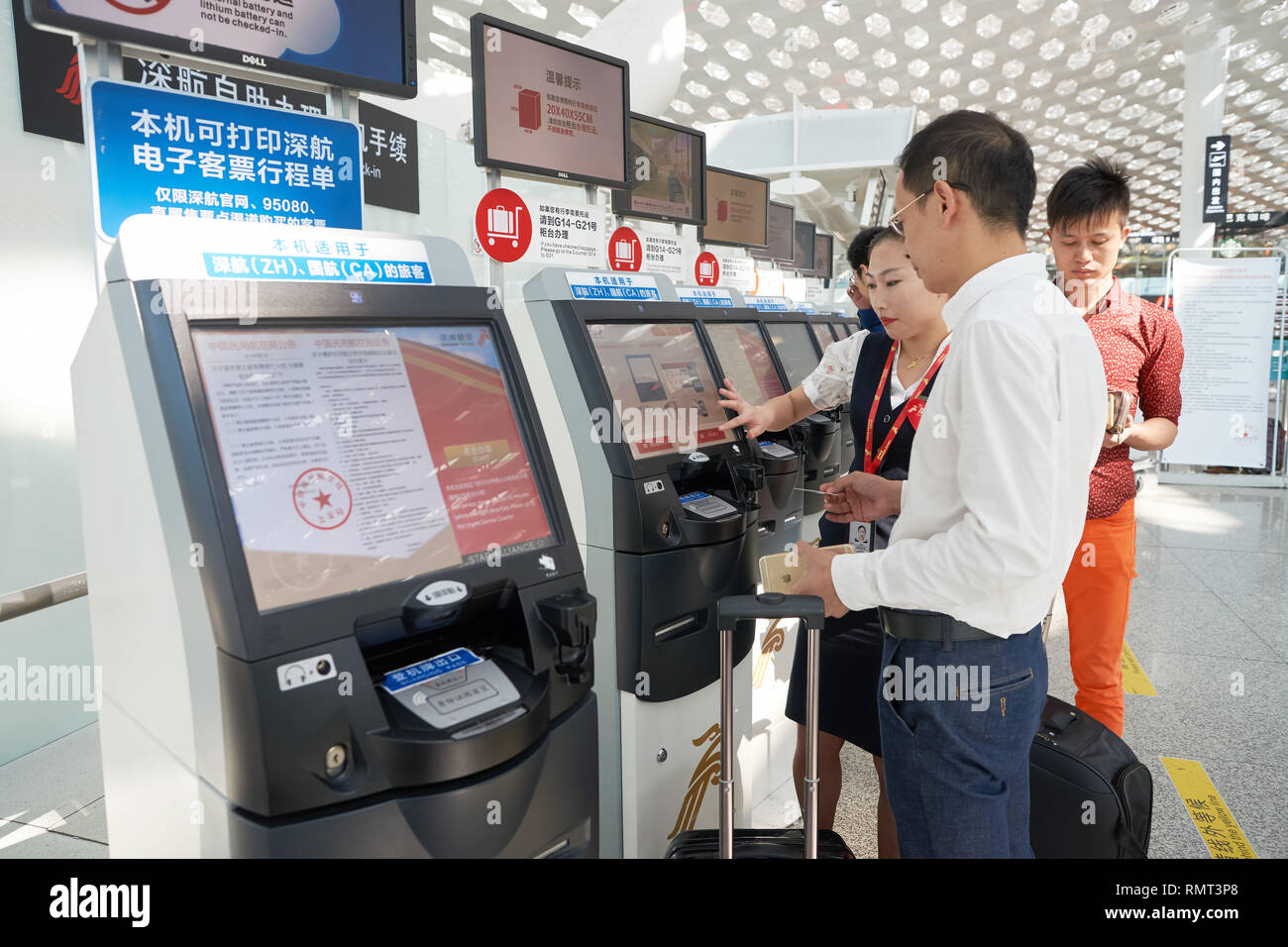 SHENZHEN, CHINA - CIRCA MAY, 2016: man use self check-in kiosk in ...