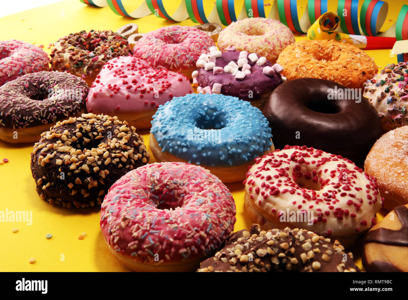 assorted donuts with chocolate frosted, pink glazed and sprinkles ...