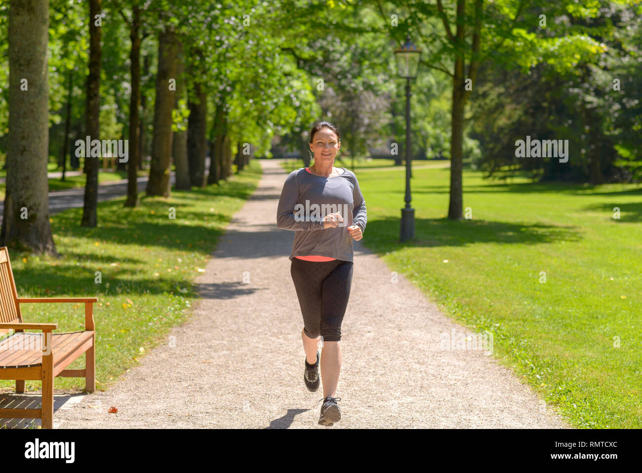 Woman running park green hi-res stock photography and images - Alamy
