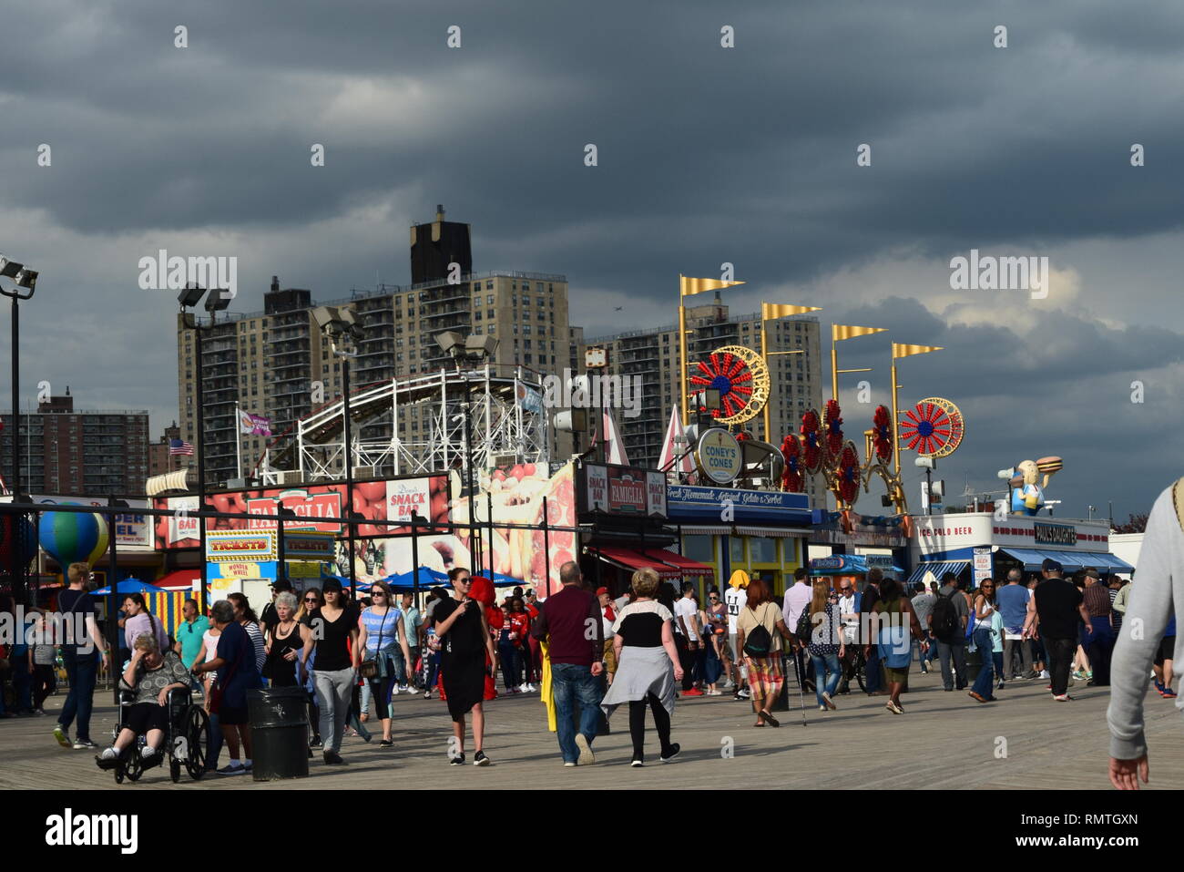 coney island boardwalk with storm clouds Stock Photo