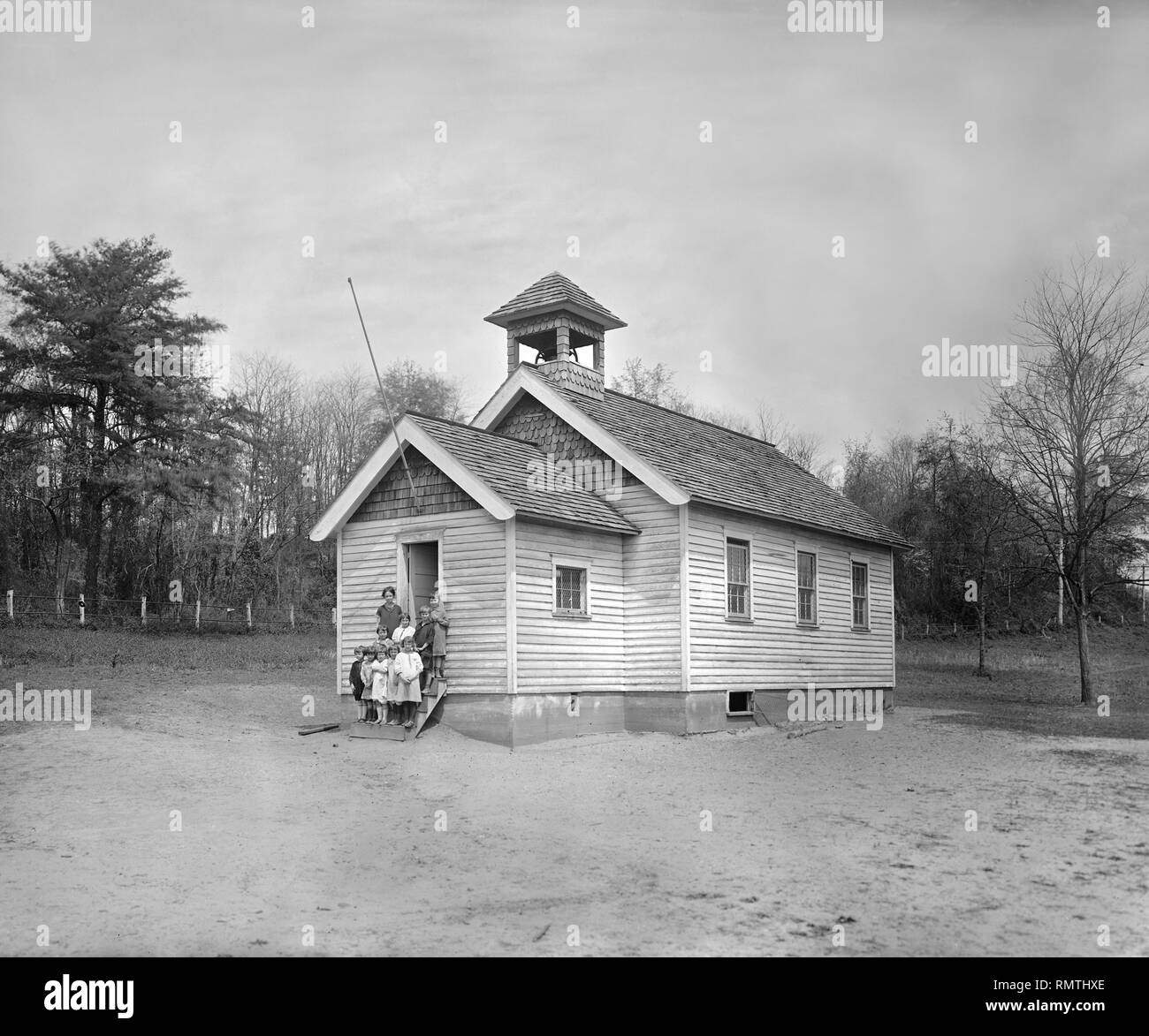 Teacher with Young Students Standing on Steps of One-Room Schoolhouse, South River Farm, Maryland, USA, National Photo Company, 1924 Stock Photo