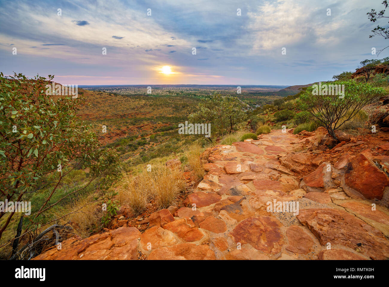 hiking kings canyon at romantic sunset, watarrka national park, northern territory, australia Stock Photo