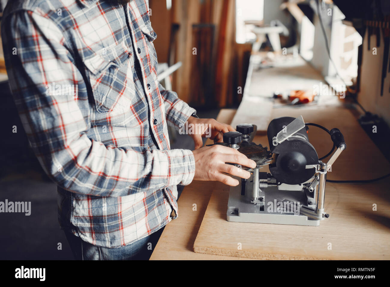 The carpenter works with a tree Stock Photo