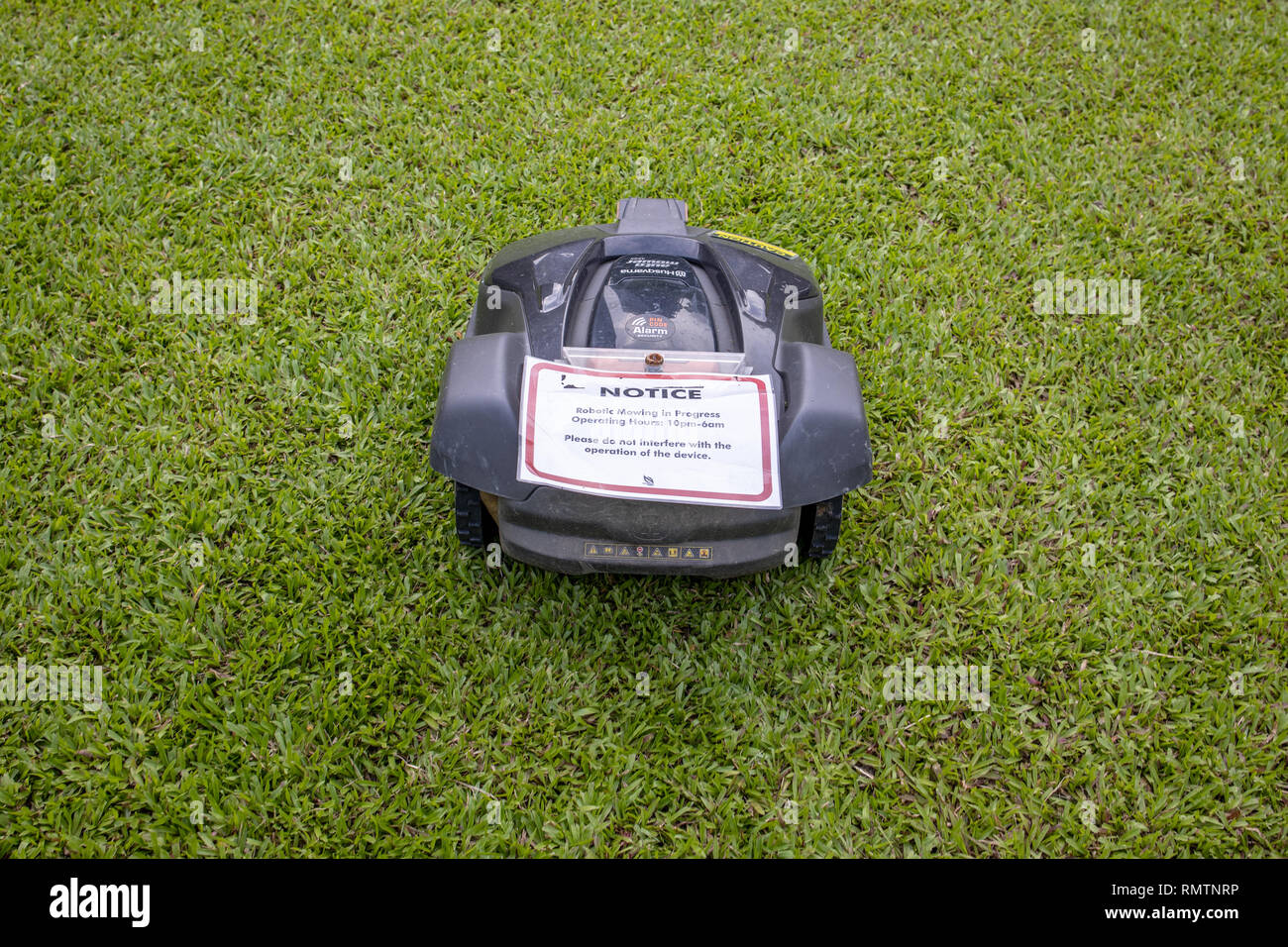 husqvarna robot lawn mower in a public park in Singapore Stock Photo