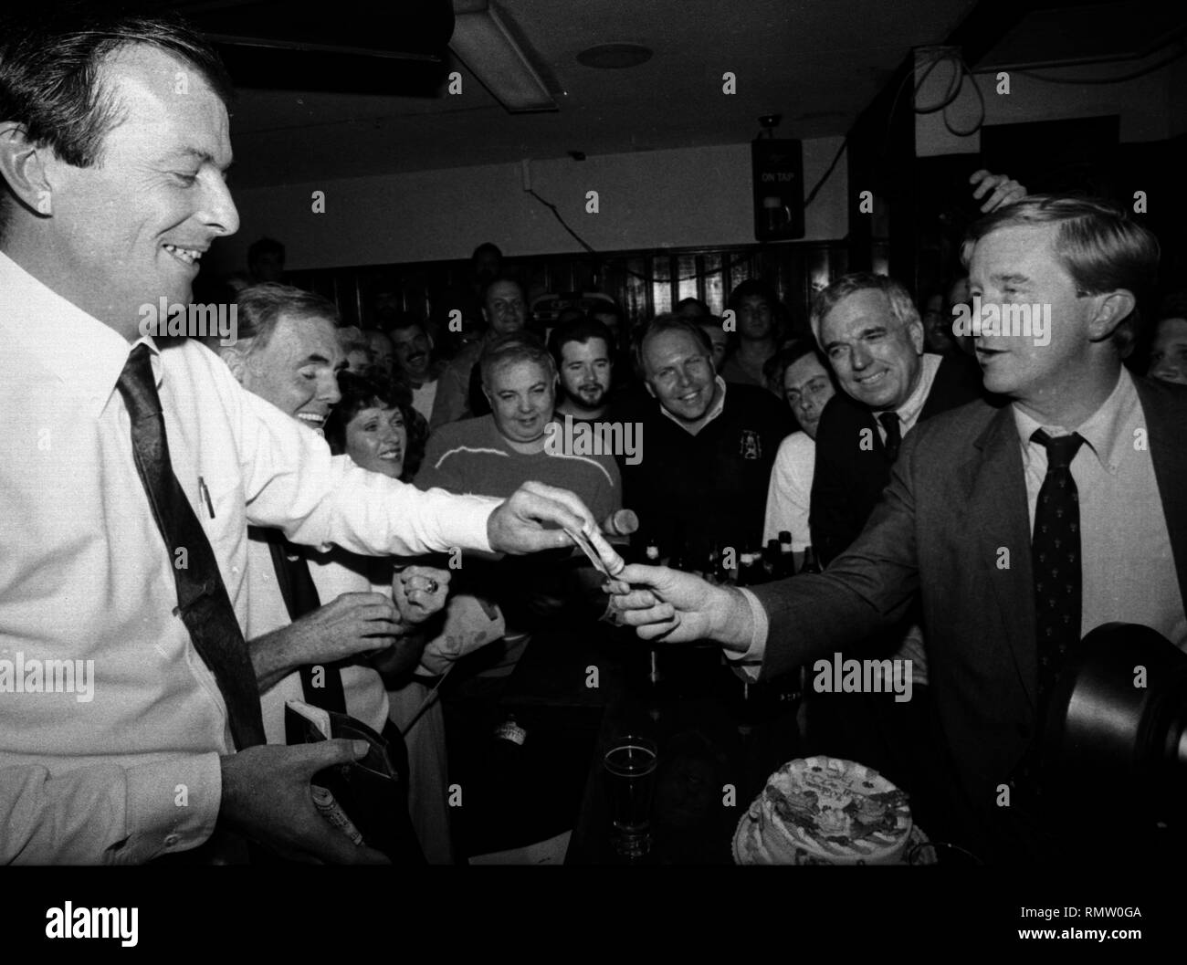Former Massachusetts Governor Bill Weld announced he will run against President Donald Trump for the Republican Presidential nomination in 2020. in this photo Massachusetts Governor Bill Weld pays his tab to Jerry Foley (left) during a campaign event at Foley's Tavern in Boston Ma USA photo by bill Belknap 1995 Stock Photo