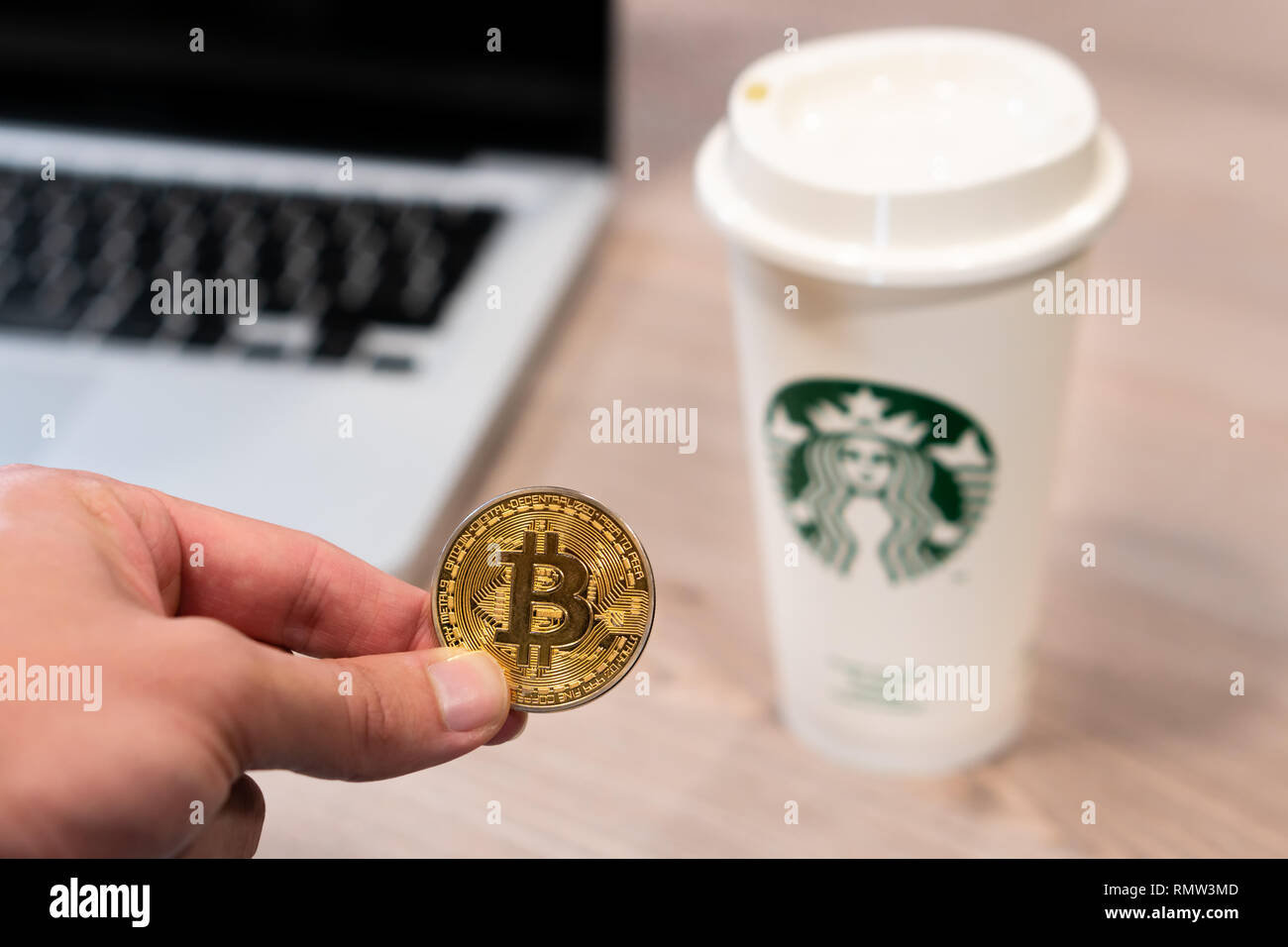 Cryptocurrency Bitcoin next to Starbucks cup. Starbucks adoption of  blockchain concept - Slovenia - 28.2.2019 Stock Photo - Alamy