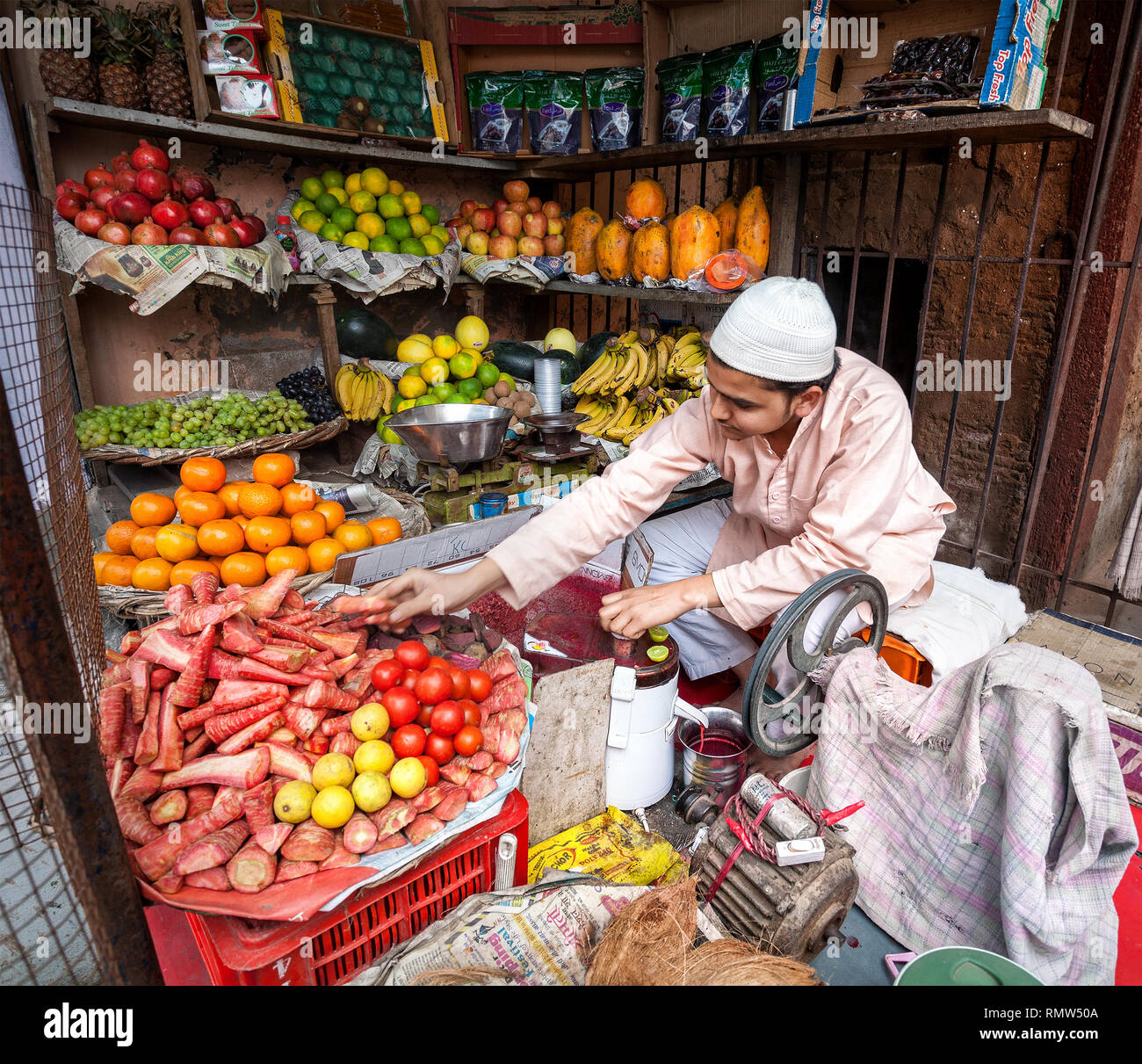 AGRA, UTTAR PRADESH, INDIA - FEBUARY 24, 2015: Muslim man making fresh carrot juice in his shop on the Taj Ganj Street Stock Photo