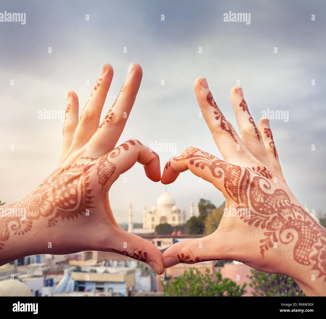 Woman hands with henna painting in shape of heart with Taj Mahal in it. I love India concept with copy space. Stock Photo