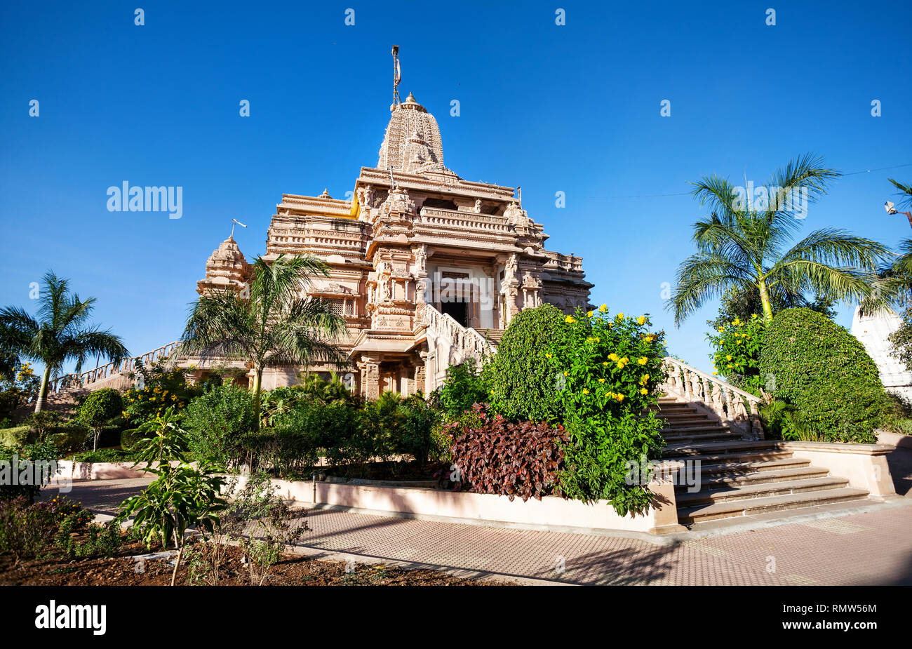 Jain temple from sandstone and tropical garden in Nasik, Maharashtra, India Stock Photo