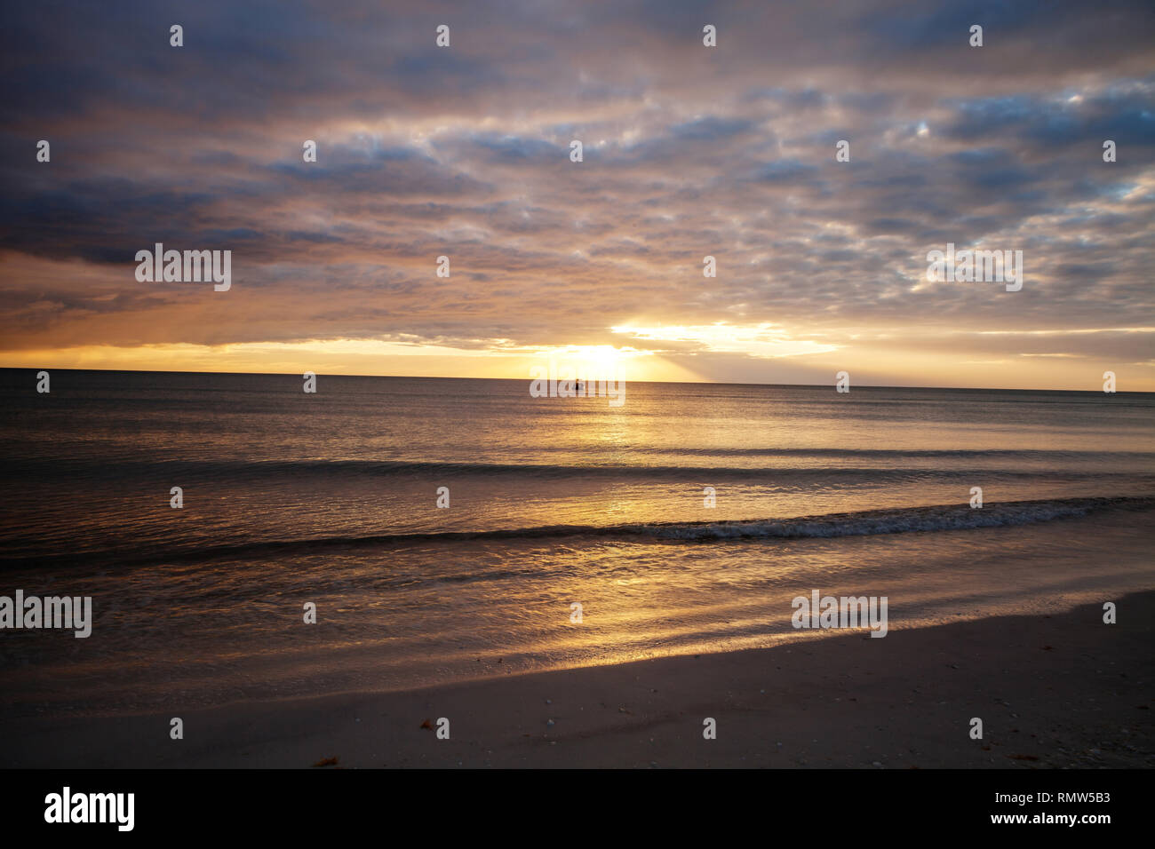 Sunset and clouds over the calm water of Tigertail Beach on Marco Island, Florida Stock Photo