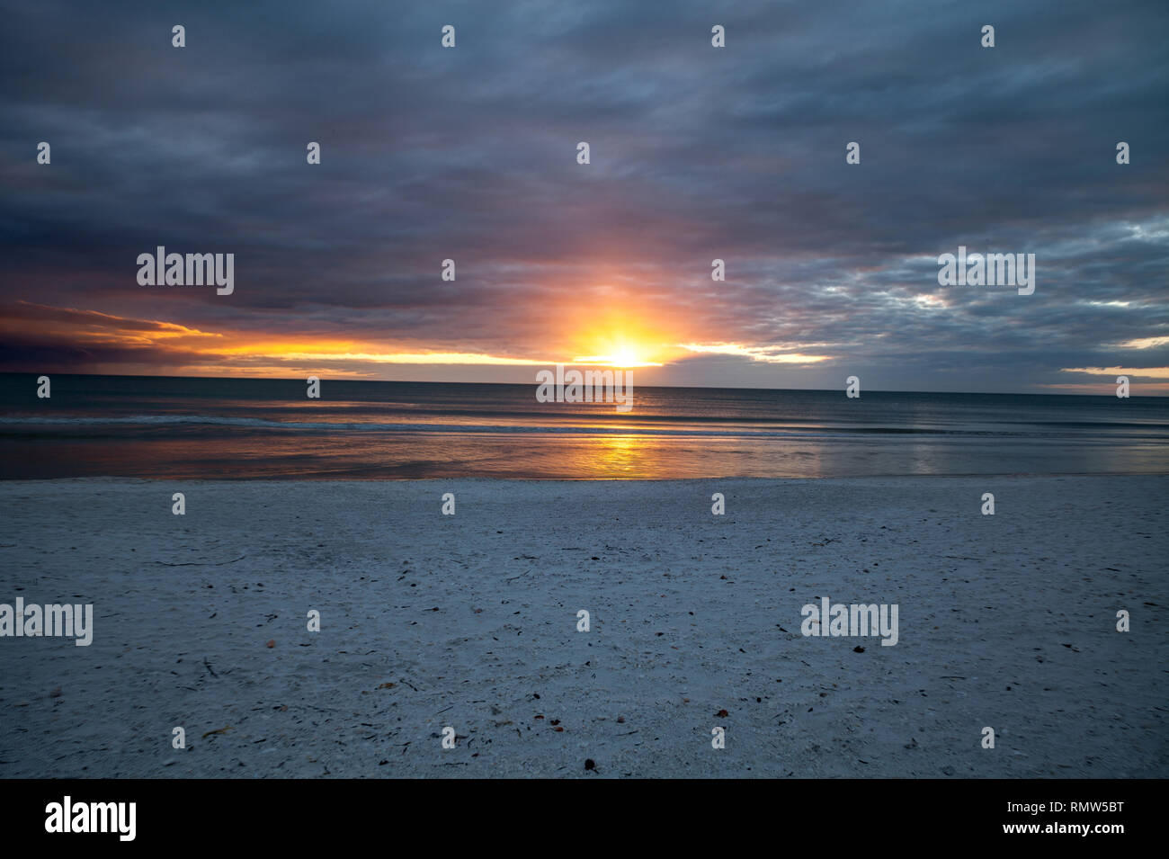 Sunset and clouds over the calm water of Tigertail Beach on Marco Island, Florida Stock Photo