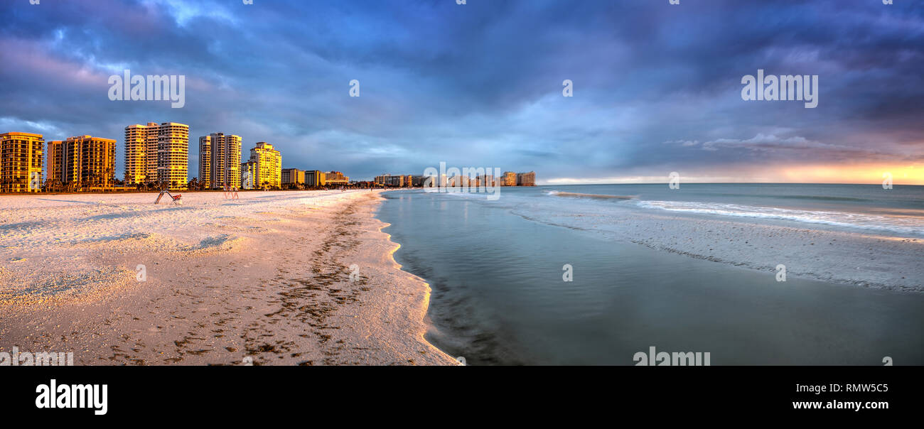 Sunset and clouds over the calm water of Tigertail Beach on Marco