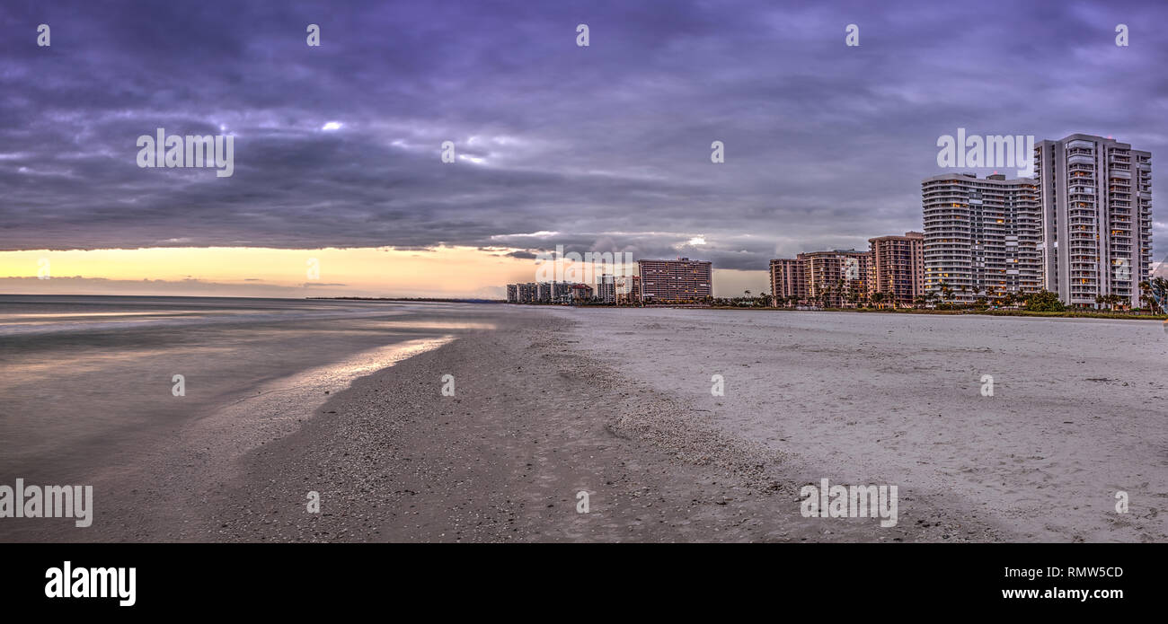 Sunset and clouds over the calm water of Tigertail Beach on Marco
