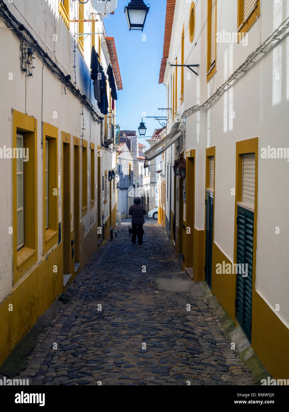 A narrow street in Evora, a Roman era town and capital of Alentejo Province, Portugal. Stock Photo