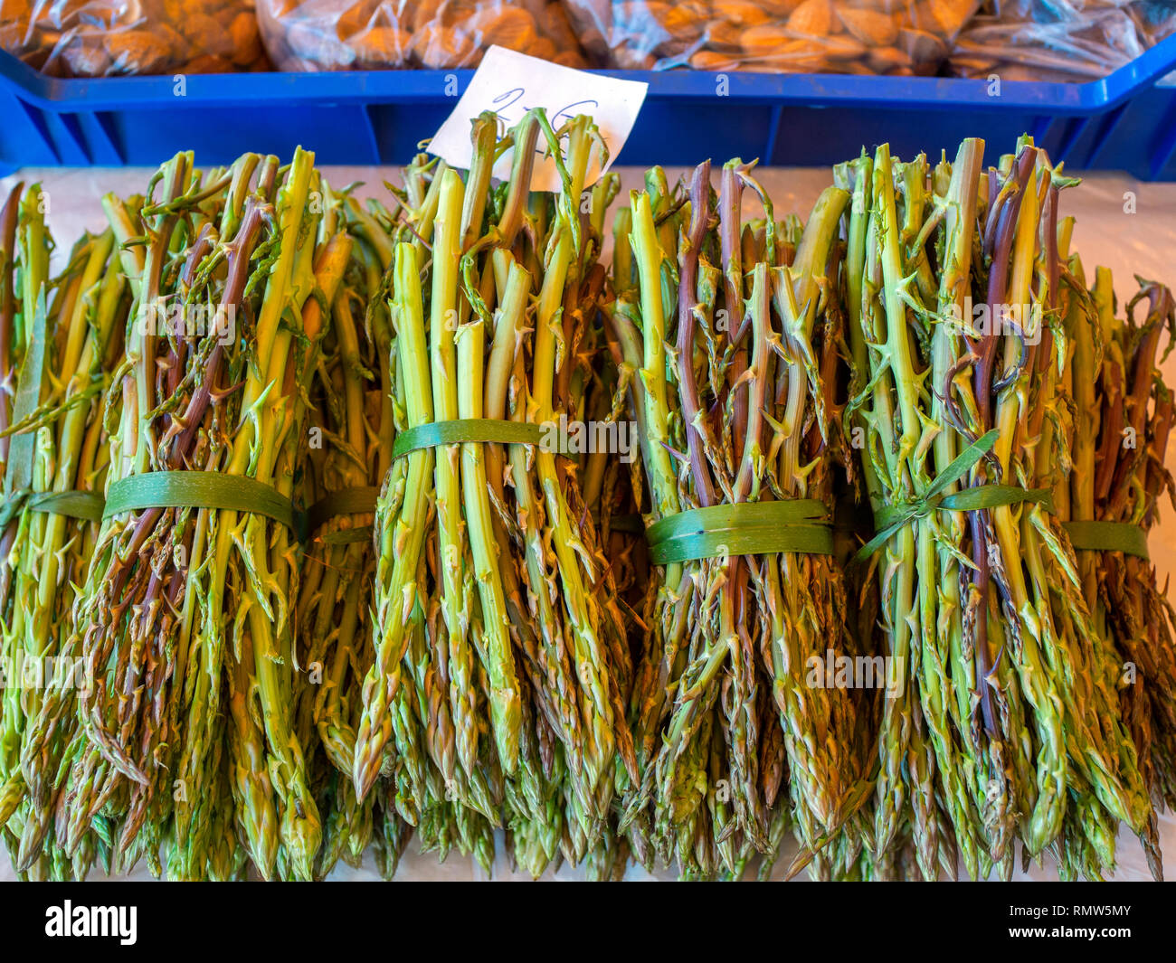 Late season asparagus with bolting spears at a Lagos vegetable market, Portugal Stock Photo