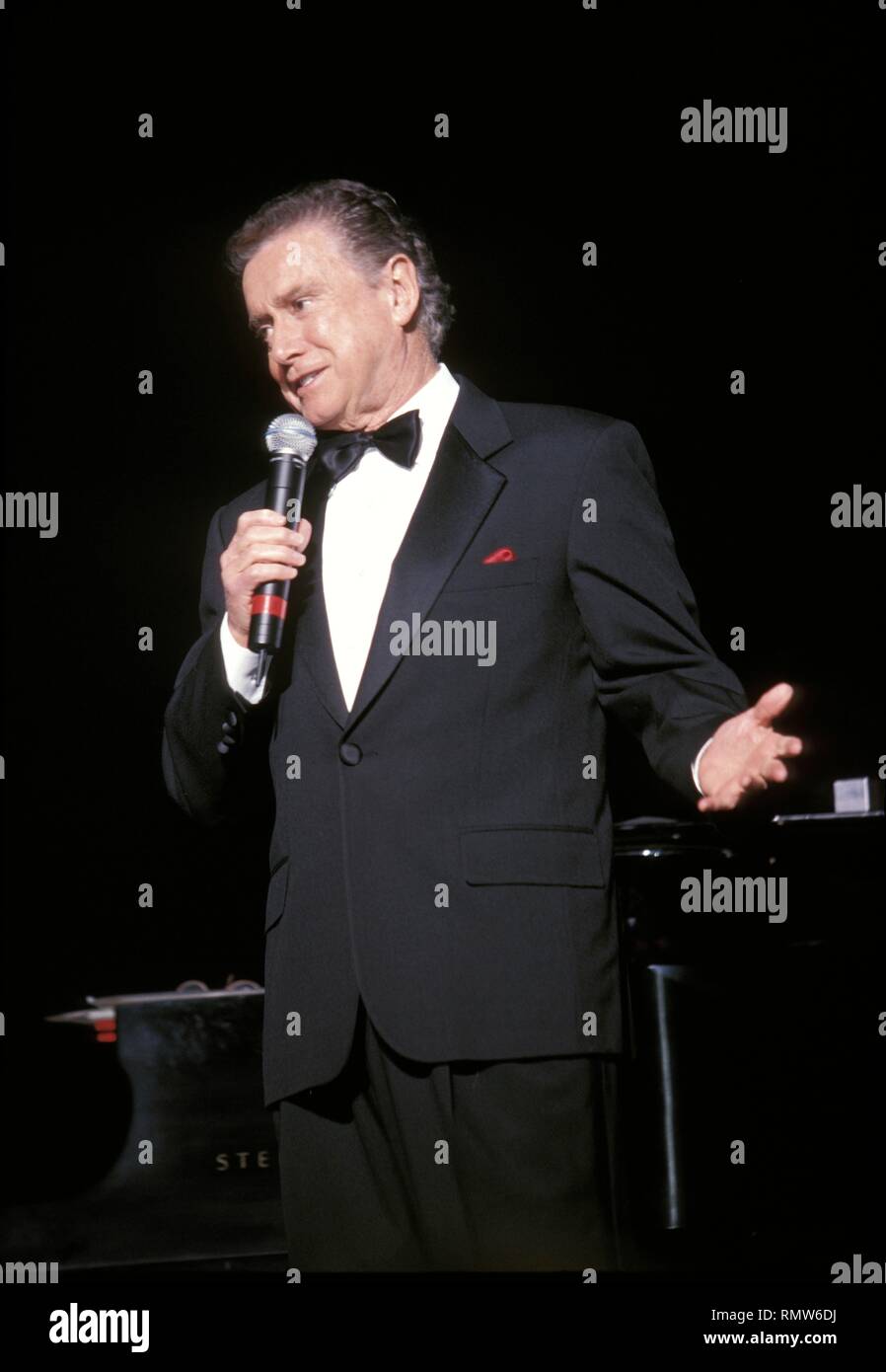 Television personality Regis Philbin is shown performing on stage ...