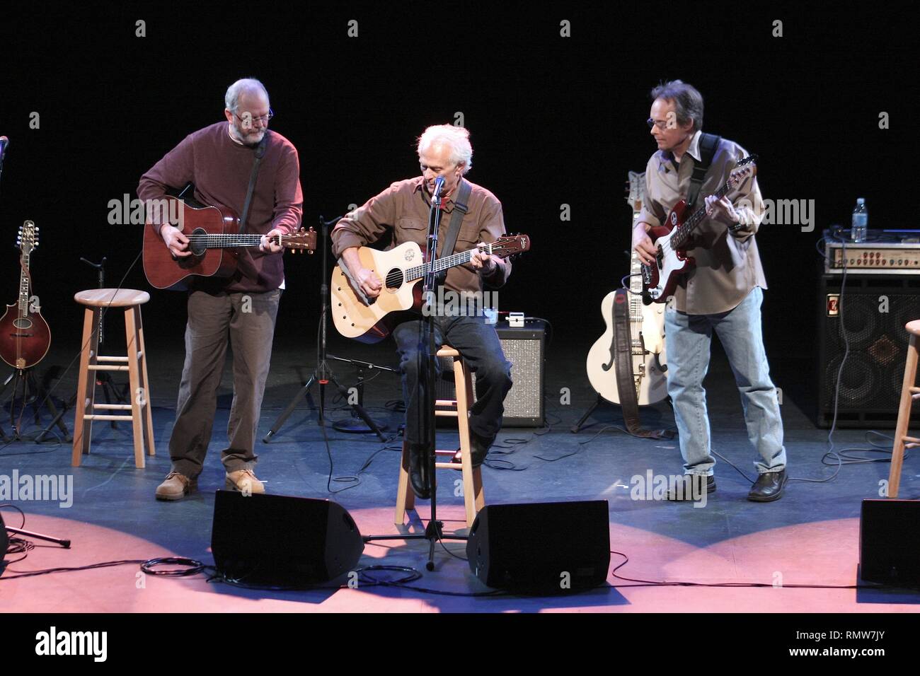 Poco are shown performing an acoustic concert performance. Stock Photo