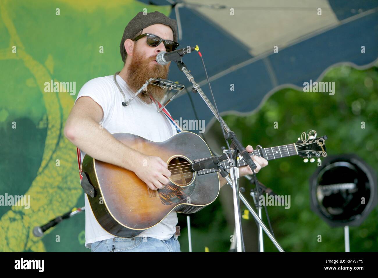 Musician Joe Purdy is shown performing on stage during a "live" concert
