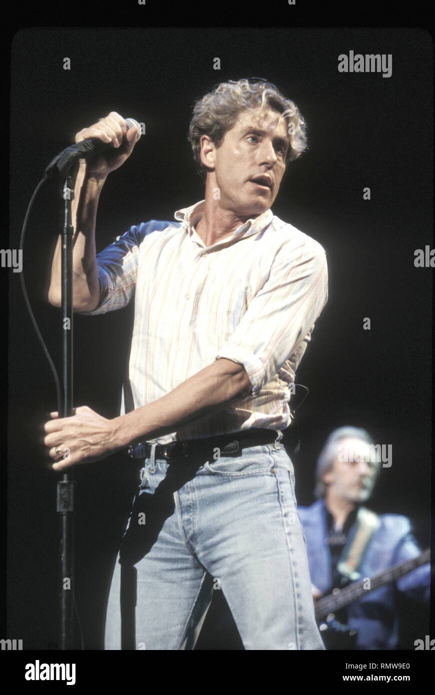 Lead Singer Roger Daltrey Of The Rock Band The Who Is Shown Performing On Stage During A Live 8653