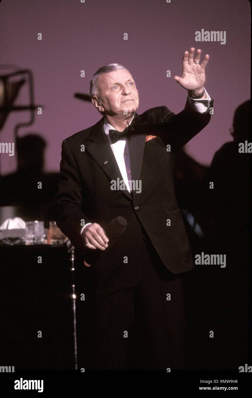 Singer and actor Frank Sinatra is shown performing on stage during a 'live' concert appearance. Stock Photo