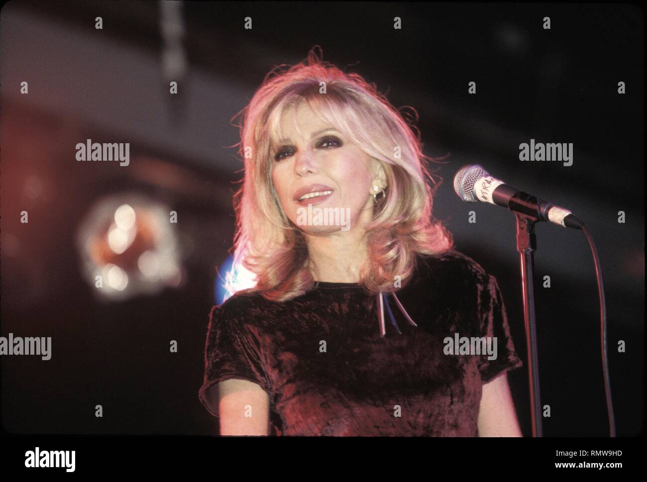 Singer and actress Nancy Sinatra, the daughter of singer & actor Frank Sinatra, is shown performing on stage during a 'live' concert appearance. Stock Photo