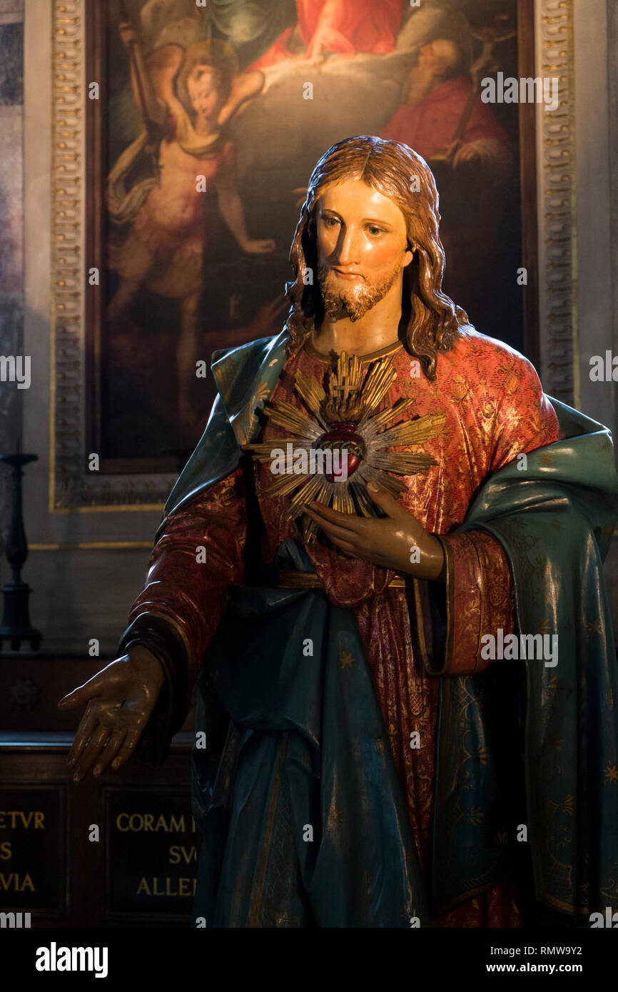 A lit statue of Jesus in a church in Milan, Italy Stock Photo - Alamy