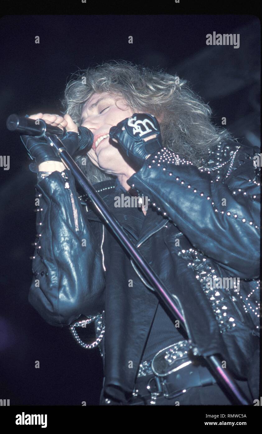 Singer David Coverdale of the hard rock band Whitesnake is shown performing on stage during a 'live' concert appearance. Stock Photo