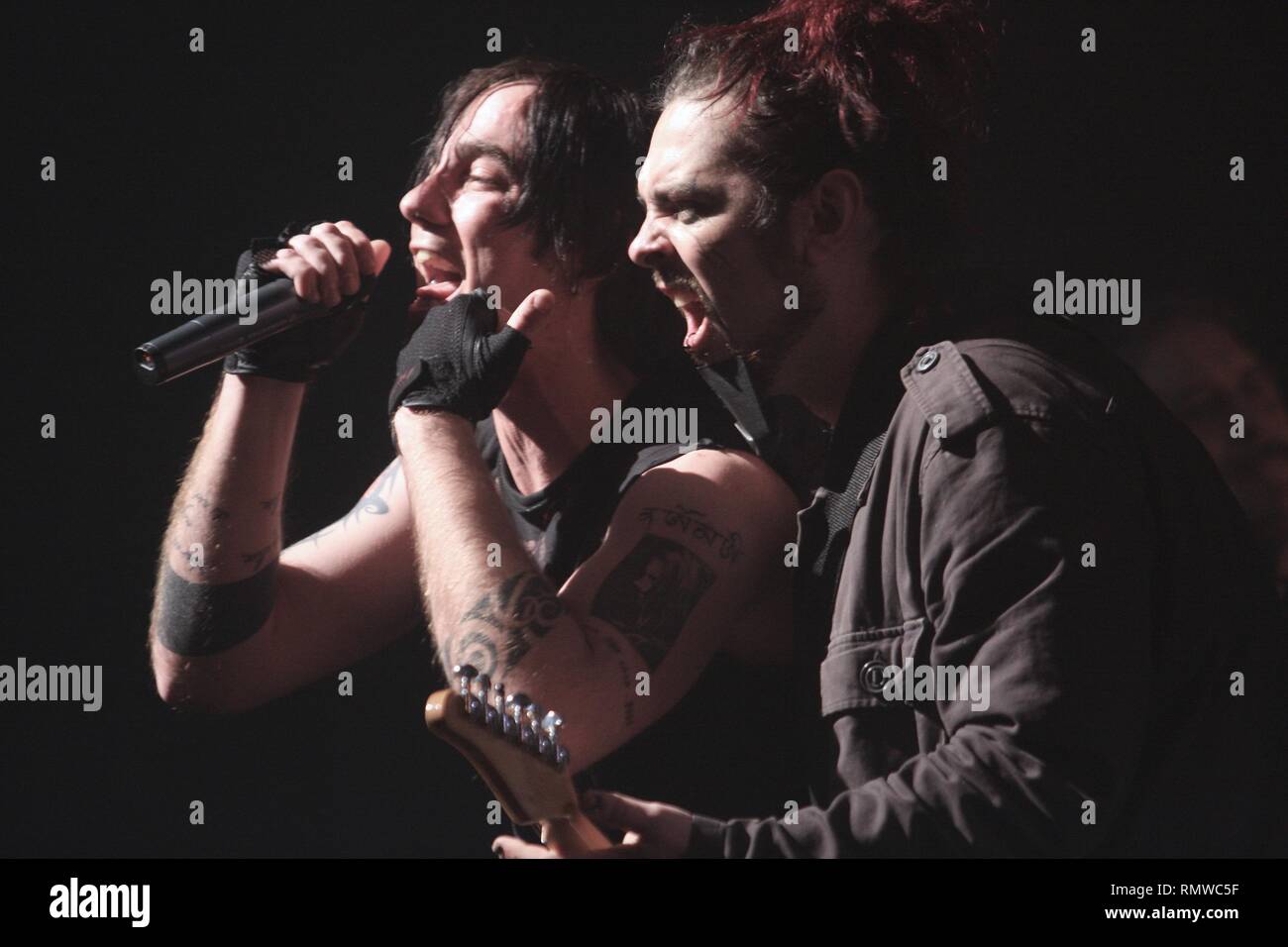 Singer Adam Gontier along with his guitarist of the alternative rock band Three Days Grace are shown performing on stage during a 'live' concert appearance. Stock Photo