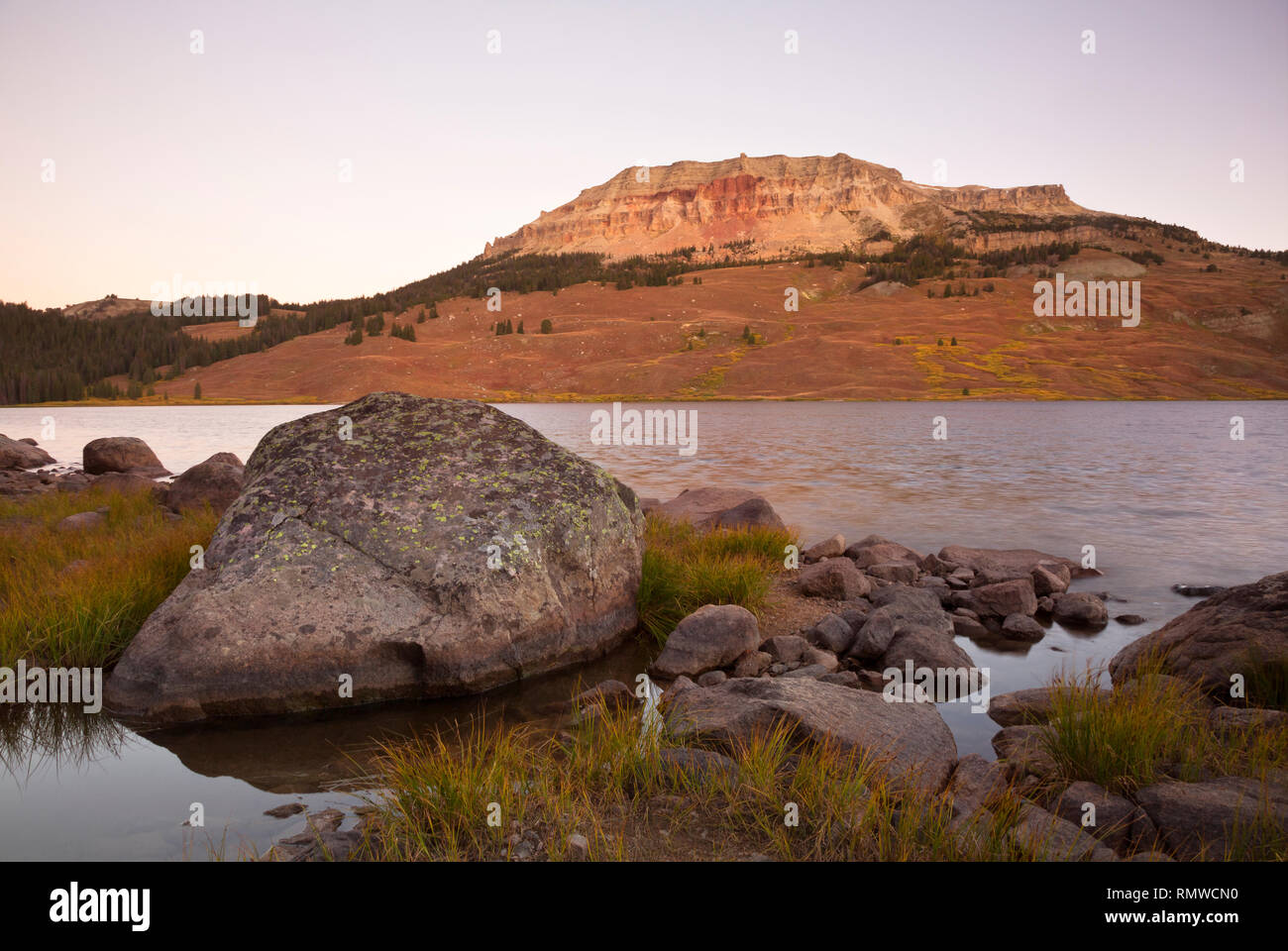 WY03778-00...WYOMING - Beatooth Butte glowing in the dawn light above Beartooth Lake in the Shoshone National Forest. Stock Photo