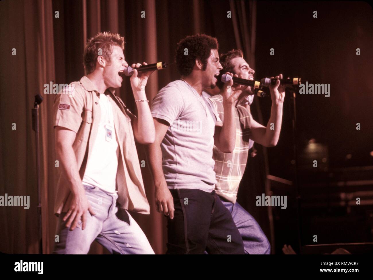 Band members of O Town are shown performing on stage during a "live