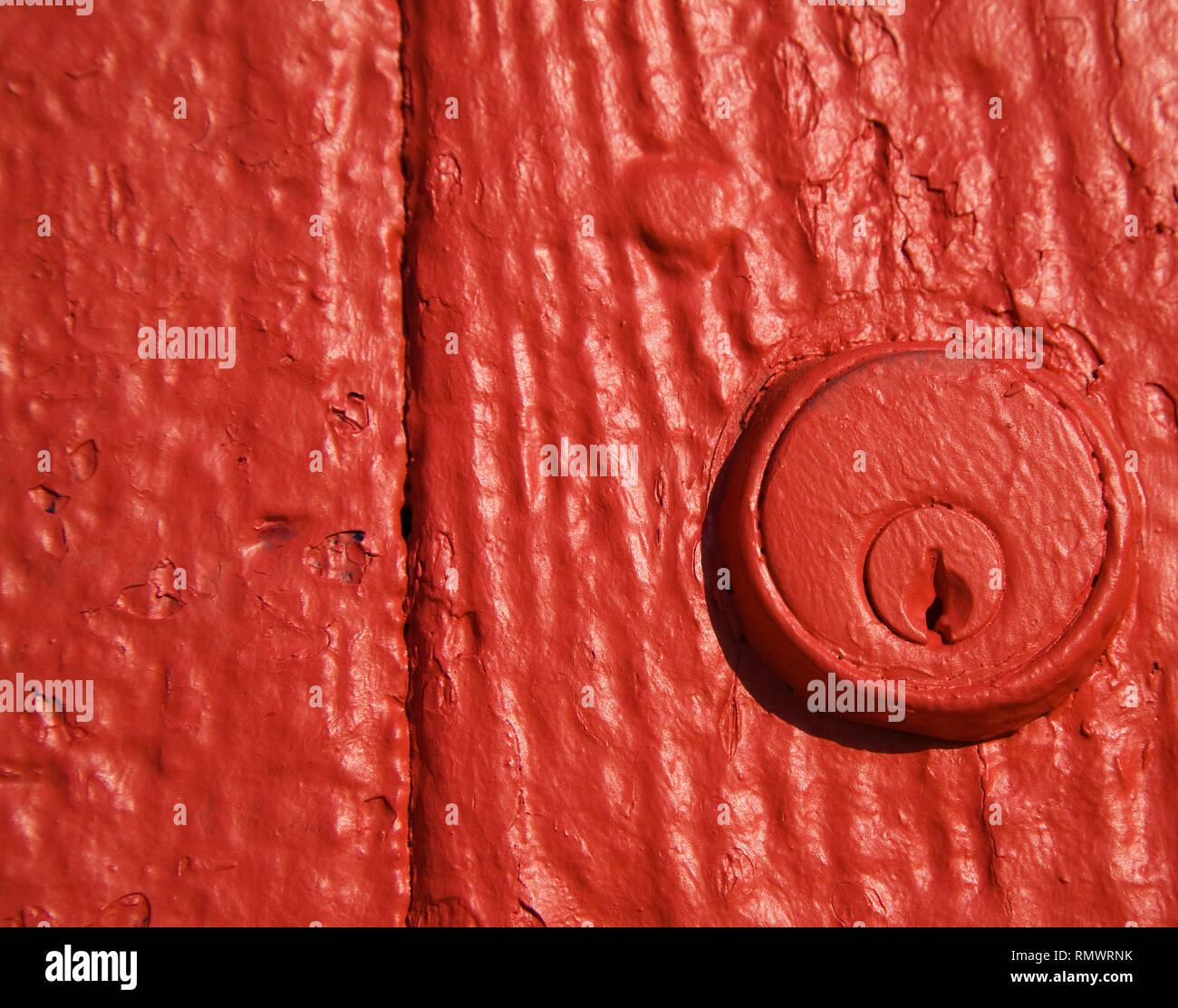 Close-up of key hole lock in door painted red Stock Photo