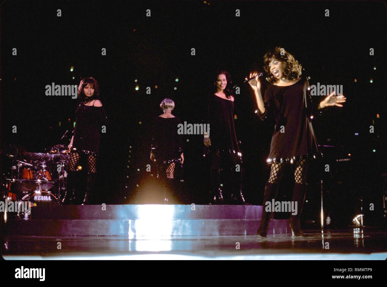 Grammy nominated female R&B vocal quartet is shown onstage during a 'live' concert appearance. Stock Photo