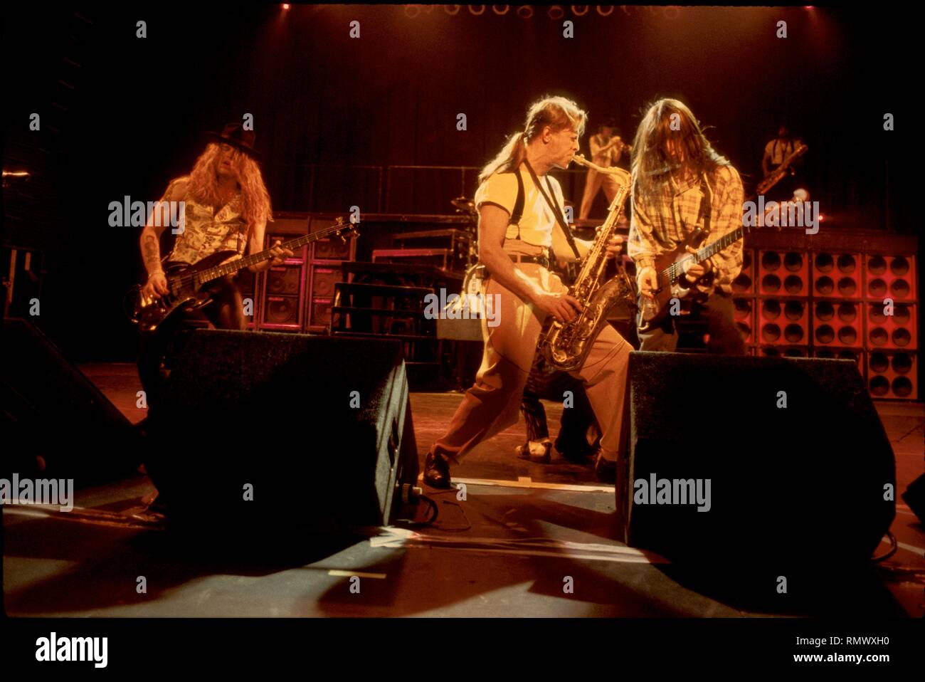 Extreme band members are shown on stage during a "live" concert