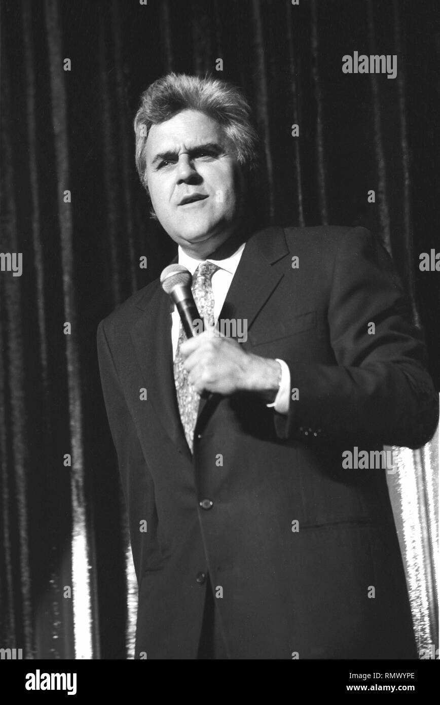 Emmy Award winning stand-up comedian and television host, Jay Leno is shown performing on stage during a 'live' concert appearance. Stock Photo