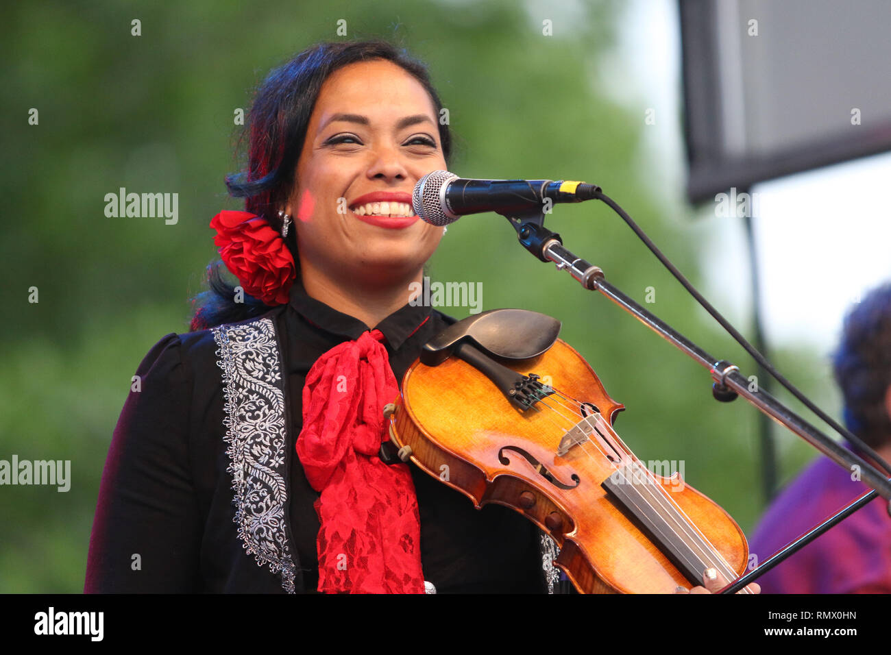 Singer and Violin player Mireya Ramos is shown performing on stage during a  "live" concert appearance with Mariachi Flor De Toloache Stock Photo - Alamy