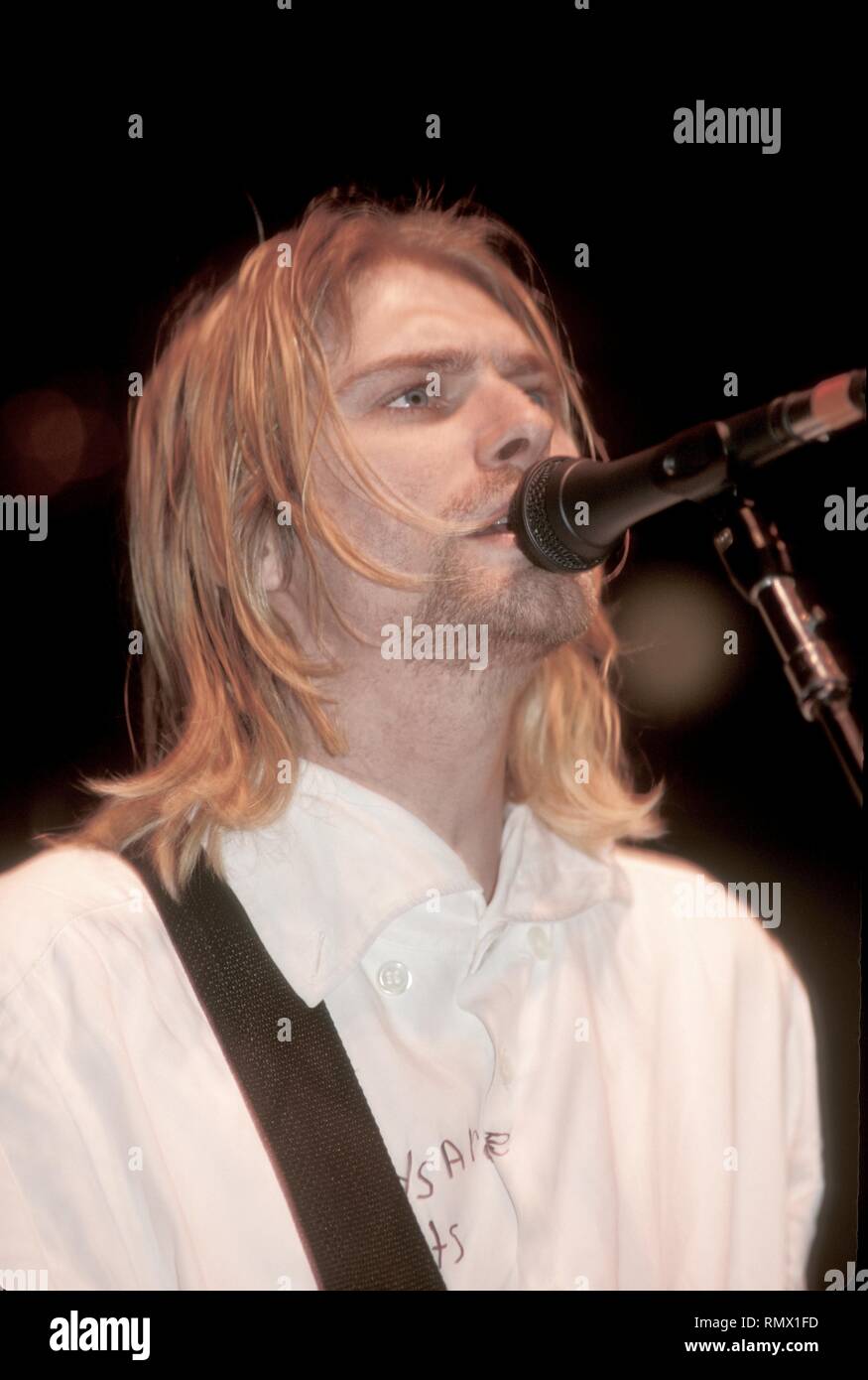 Singer and guitarist Kurt Cobain of the rock band Nirvana is shown performing on stage during a 'live' concert appearance. Stock Photo