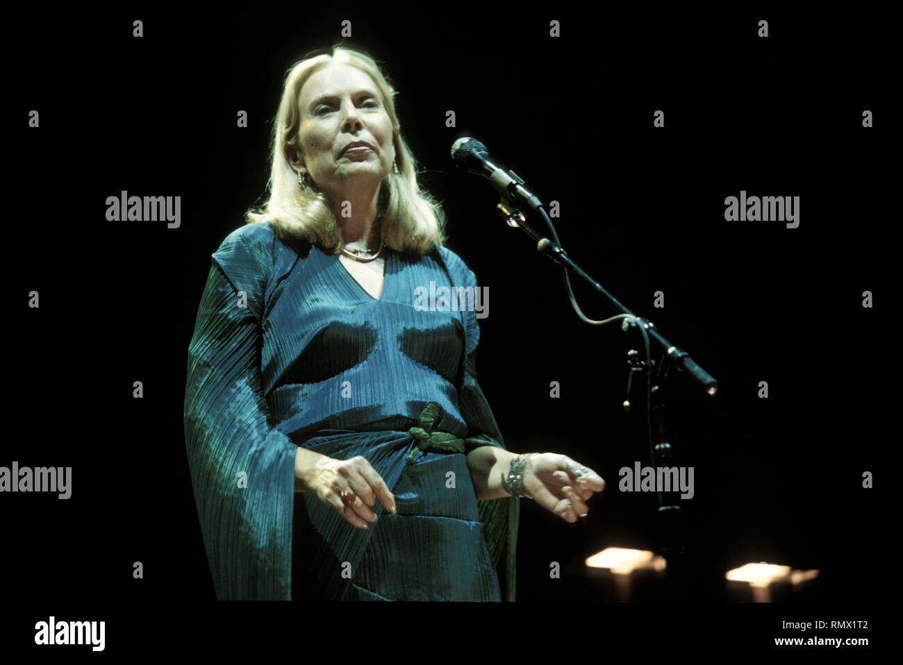 Canadian singer, musician, songwriter, and painter Joni Mitchell is shown performing on stage during a 'live' concert appearance. Stock Photo